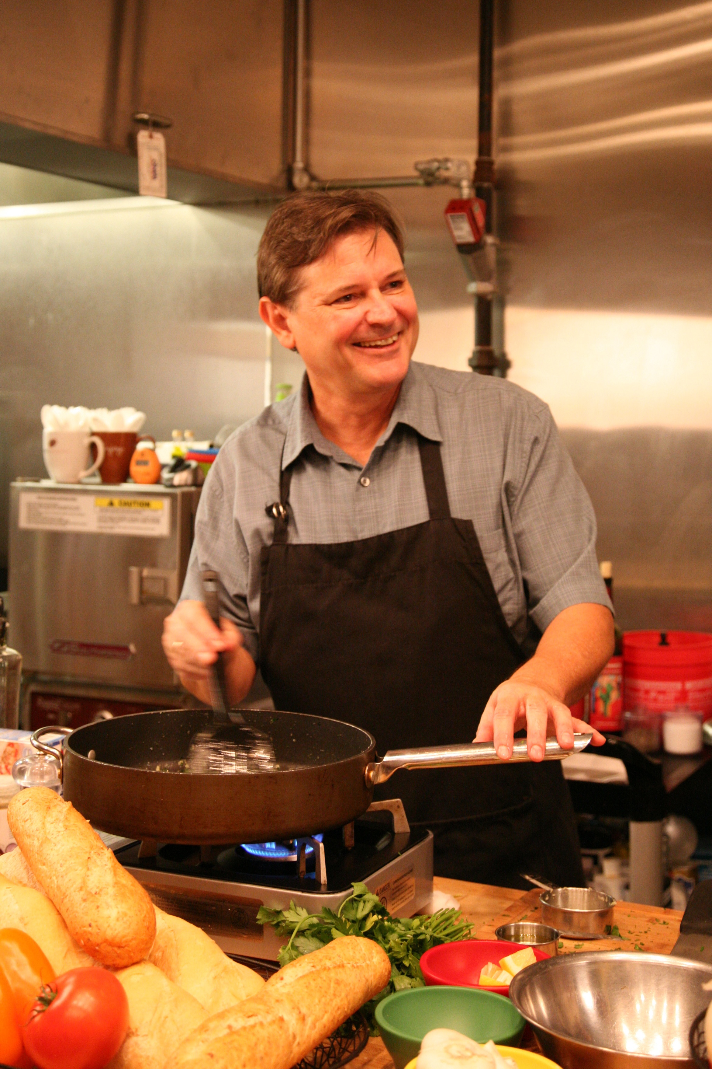 Chef Warren cooks over a hot pan.