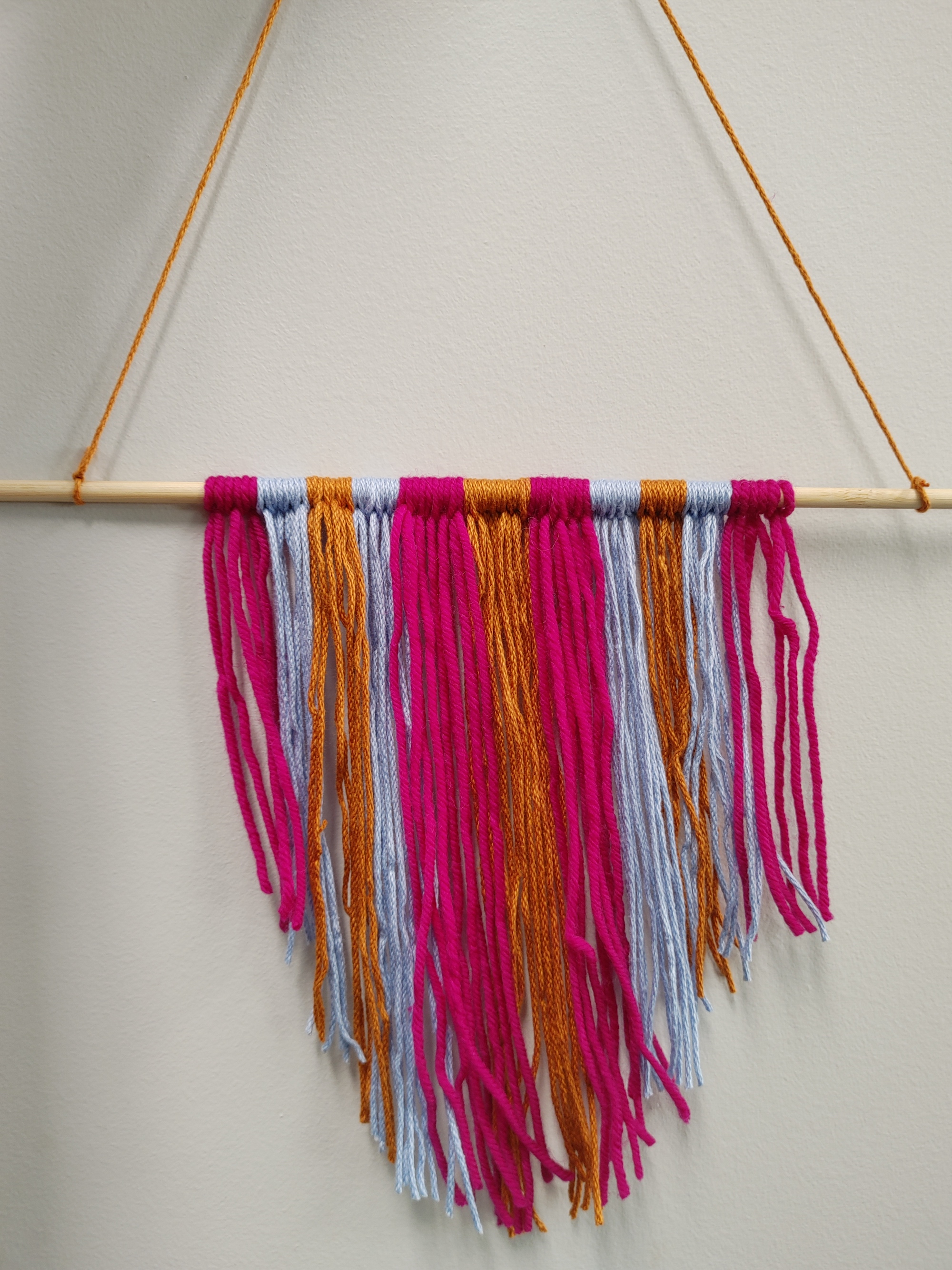 Maroon and purple yarn wall hanging