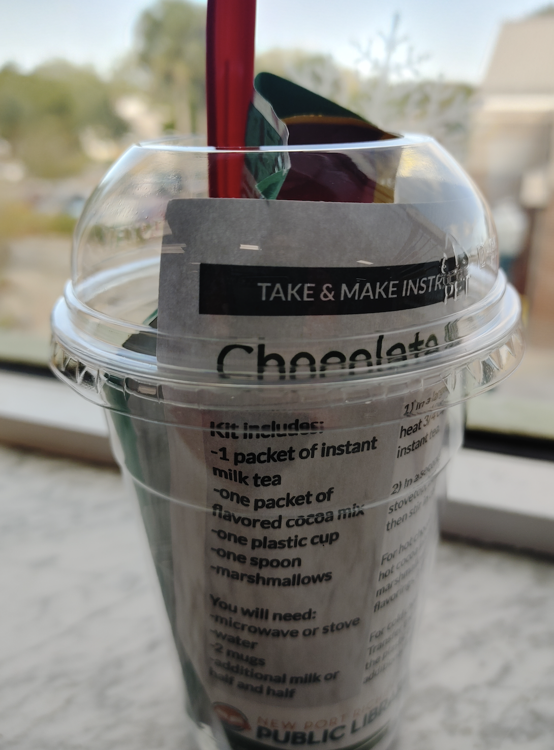 Plastic cup with chocolate milk tea ingredients