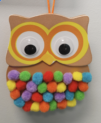 Craft owl made with pom poms.