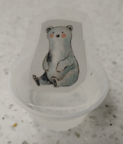 Laminated polar bear in ice cup