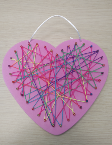 Pink heart with string