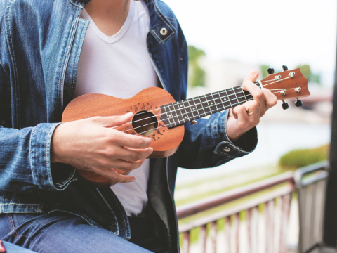 Young woman playing ukelele