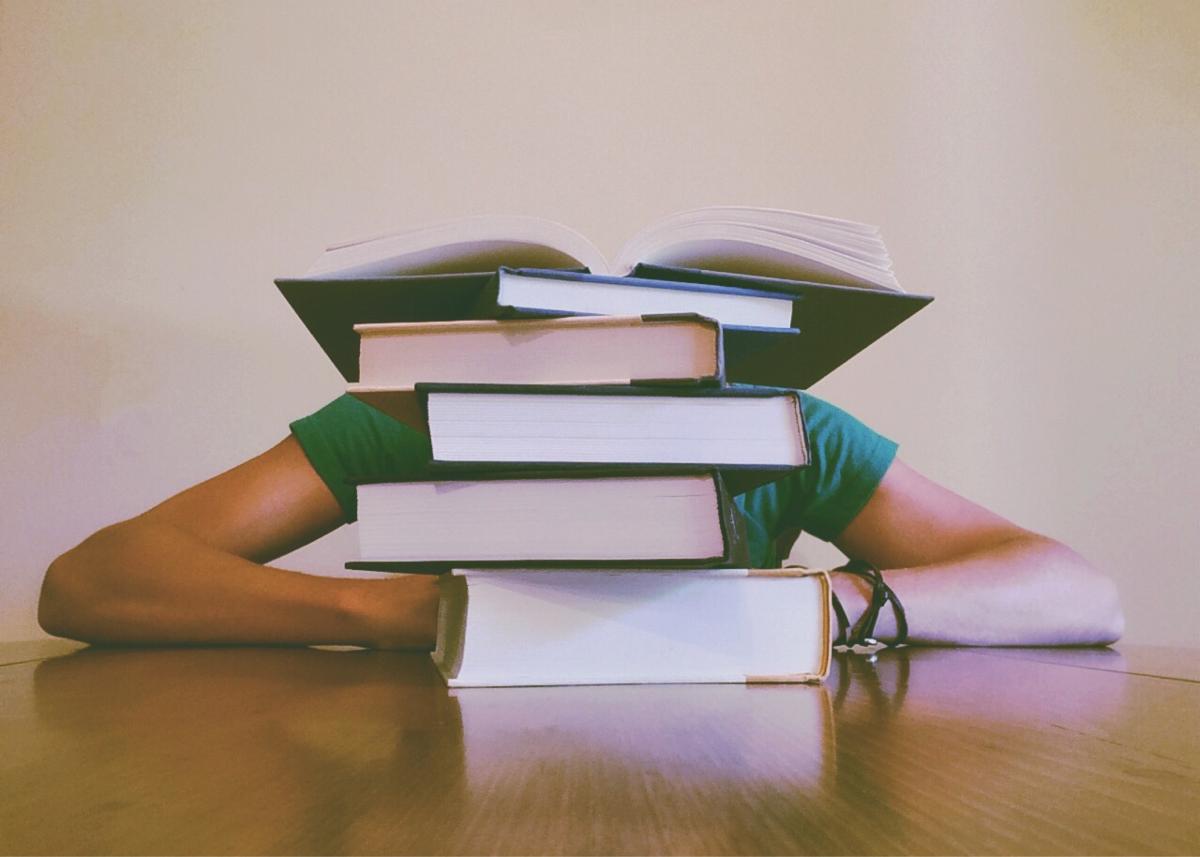 Stressed teen with books