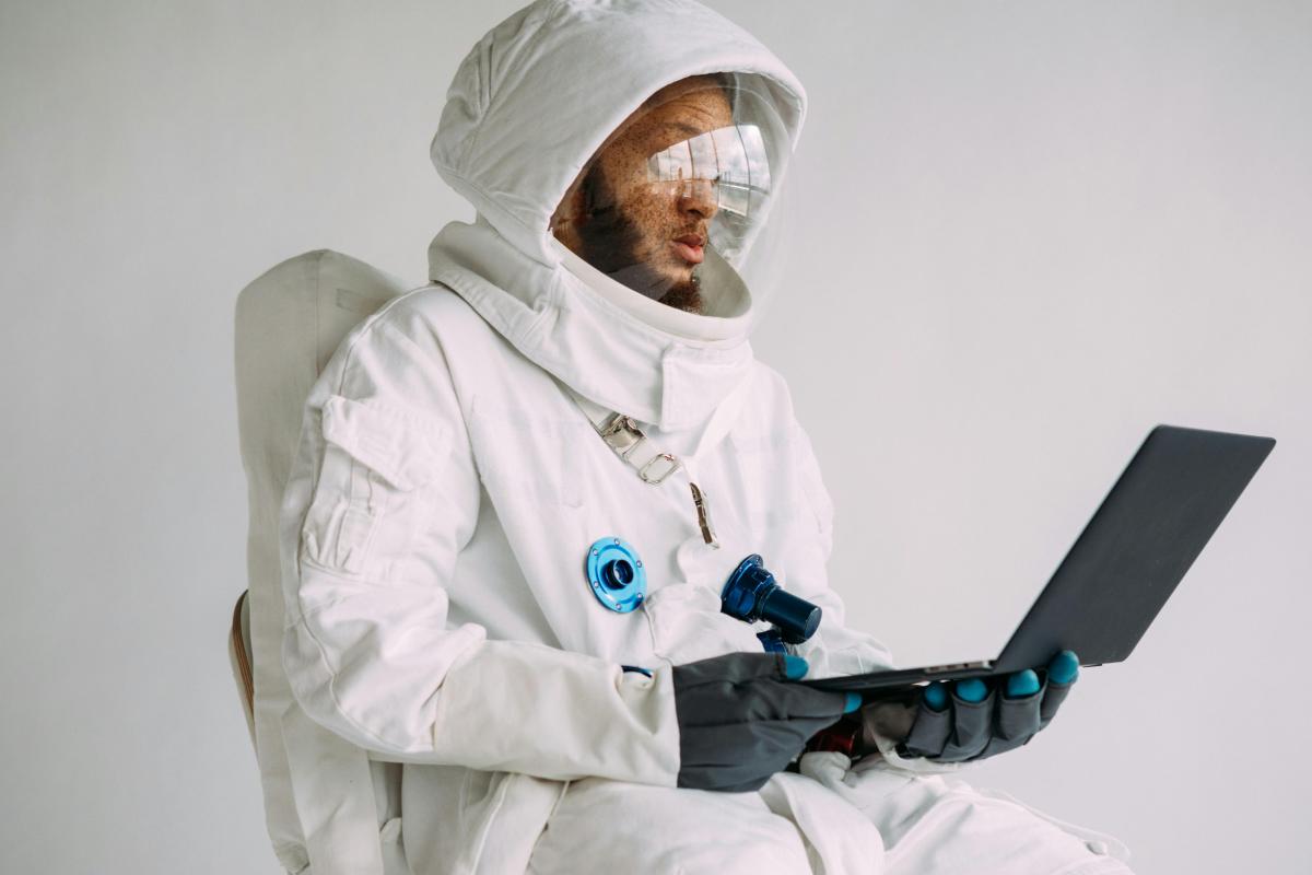 Astronaut looking at laptop